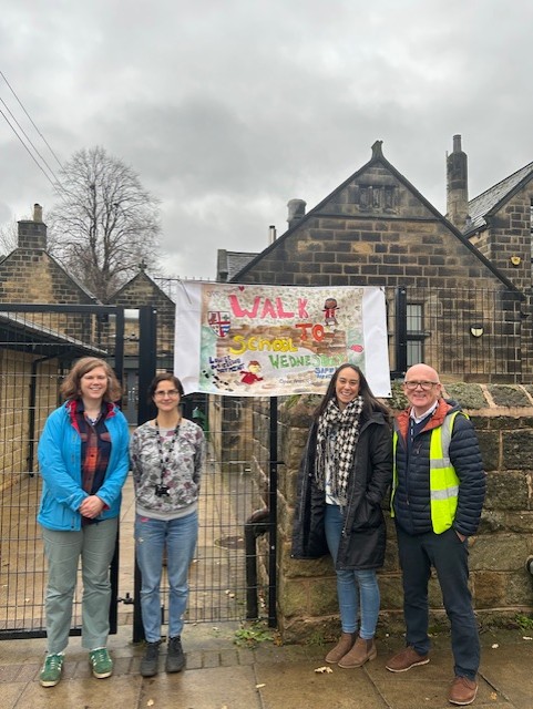 Climate Ambassadors and sustainability staff outside the school smiling.